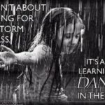 Photo of a child dancing in the rain