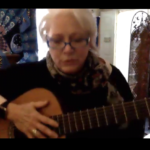 Photo of Christy K. with her guitar.